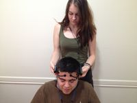 Emma, an intern at the lab, prepares a participant for EEG recording
